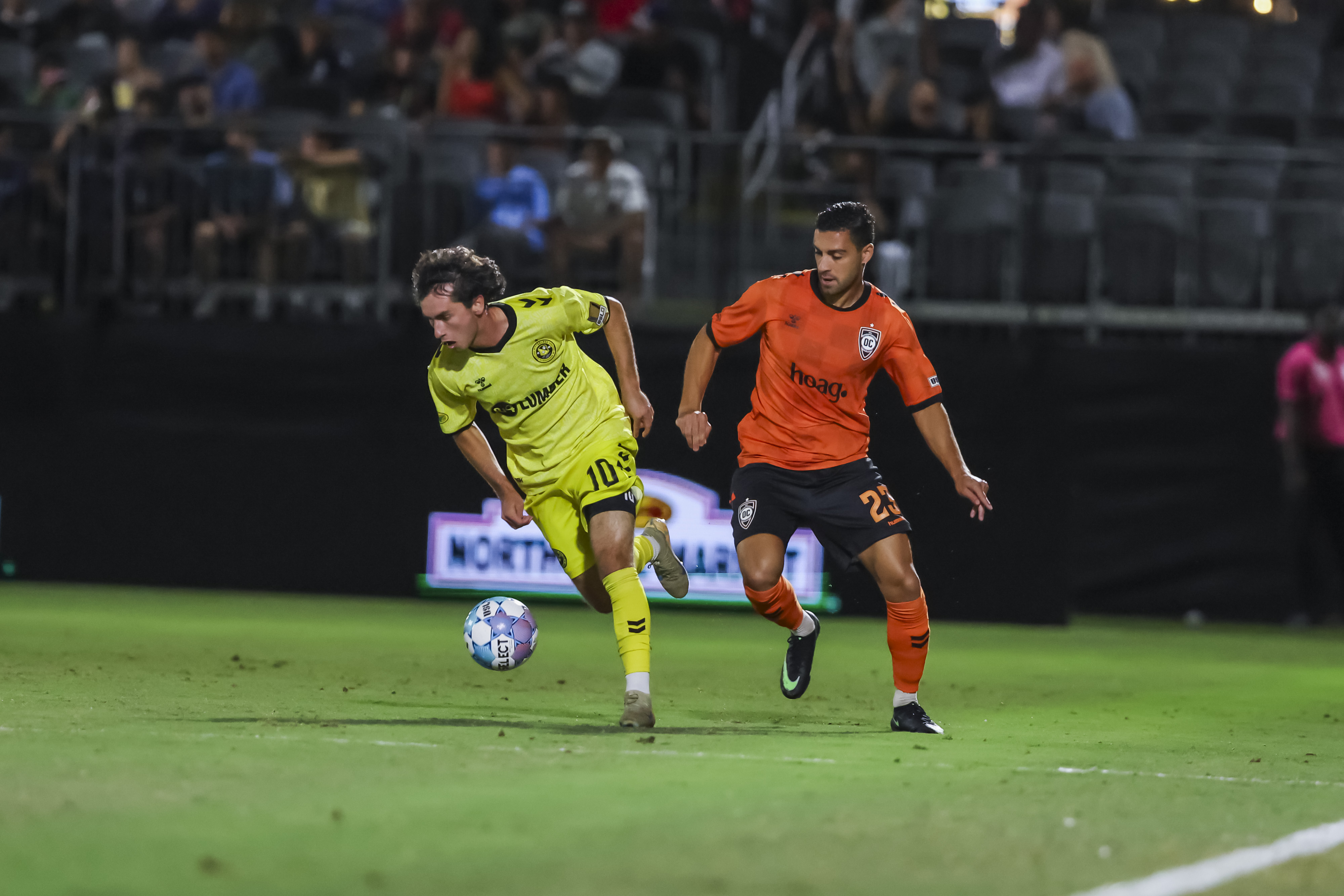 Charles Ahl dribbles away from Orange County SC defender Ryan Doghman in the Pittsburgh Riverhounds' match on Sept. 26, 2026 at Championship Soccer Stadium in Irvine, Calif. (Photo: Orange County SC)