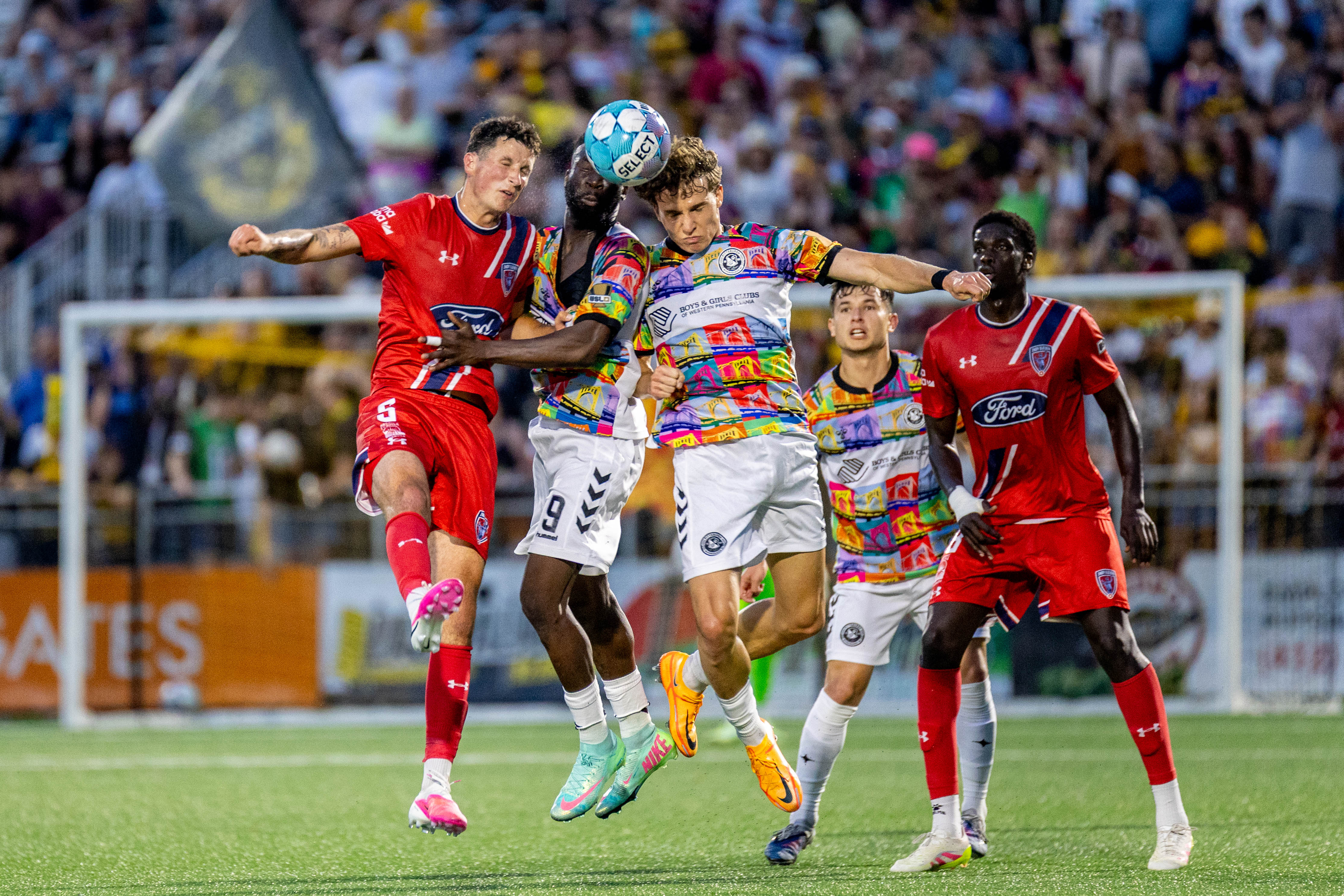 Pittsburgh Riverhounds teammates Albert Dikwa (center) and Lasse Kelp push past Indy Eleven's Josh O'Brien (left) to win a header in the Hounds' 1-0 victory on June 13, 2026 at F.N.B. Stadium in Pittsburgh. (Photo: Chris Cowger/Riverhounds SC)