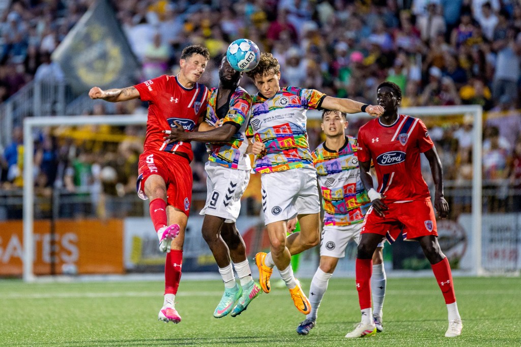 Pittsburgh Riverhounds teammates Albert Dikwa (center) and Lasse Kelp push past Indy Eleven's Josh O'Brien (left) to win a header in the Hounds' 1-0 victory on June 13, 2026 at F.N.B. Stadium in Pittsburgh. (Photo: Chris Cowger/Riverhounds SC)
