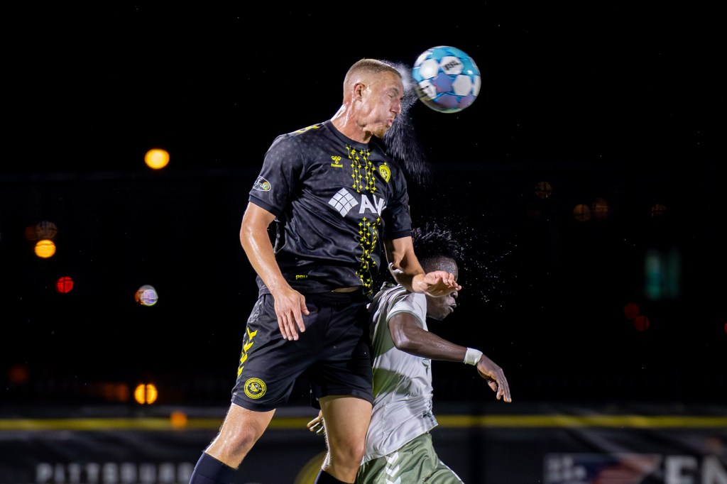 Pittsburgh Riverhounds defender Owen Mikoy leaps to head the ball in the rain during his team's 2-1 win over Hartford Athletic on Oct. 10, 2026 at F.N.B. Stadium in Pittsburgh. (Photo: Chris Cowger/Riverhounds SC)