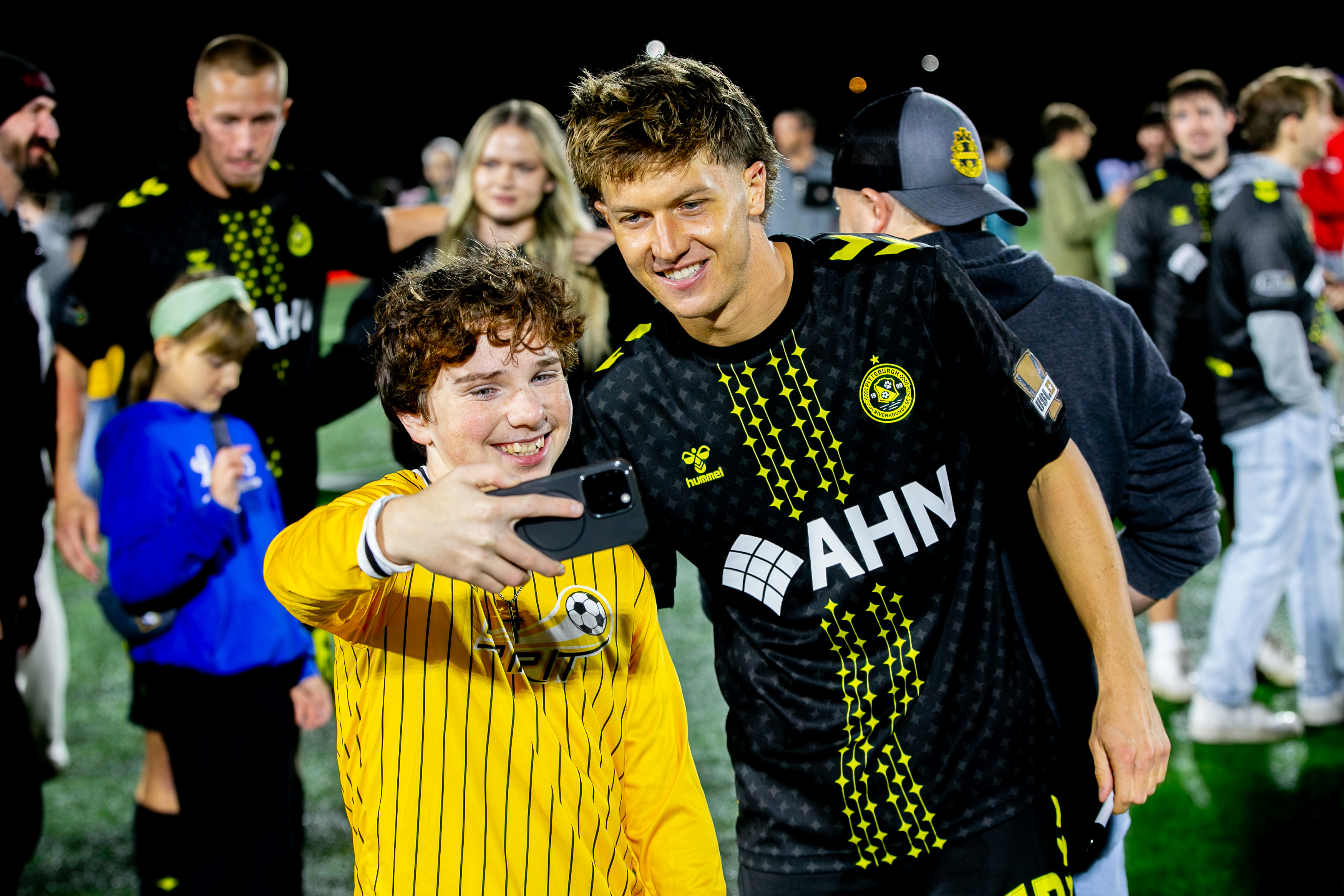 Pittsburgh Riverhounds midfielder Sam Bassett smiles for a photo with a fan after the team's 2-1 win over Hartford Athletic on Oct. 10, 2026 at F.N.B. Stadium in Pittsburgh. (Photo: Chris Cowger/Riverhounds SC)