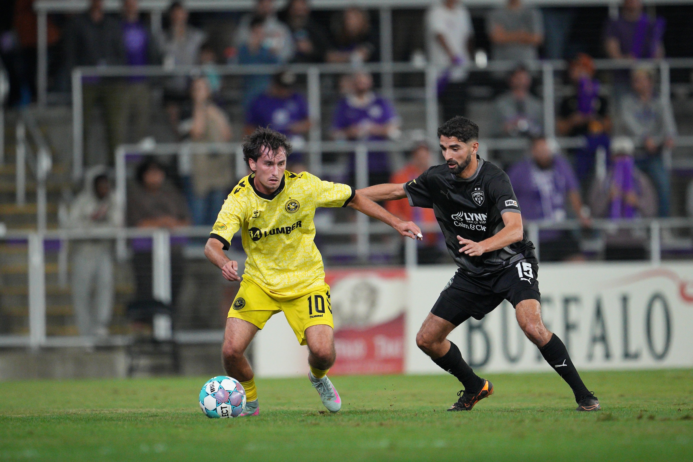 Charles Ahl dribbles away from Louisville City FC's Manny Perez in the Pittsburgh Riverhounds USL Championship Playoffs match on Oct. 30, 2026 at Lynn Family Stadium in Louisville, Ky. (Photo: EM Dash Photography/Louisville City FC)